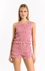 Red and white gingham sleeveless top featuring a fully shirred body and a ruffled hemline
