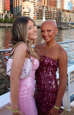 Front view of a fitted pink sequin strapless mini dress with a straight neckline