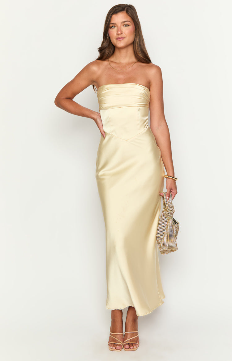 Front view of a yellow strapless maxi dress with a ruched bodice and V-shaped waist seam