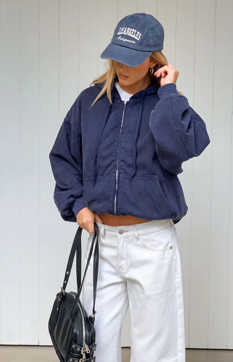 Front view of a washed navy oversized hooded jacket with a silver full zip and front pockets