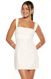 White mini dress with a square neckline, wide shoulder straps, ruched bodice, and subtle vertical stripe texture