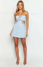 Light blue strapless mini dress with ruffled trim, front drawstring detail, and side waist cutouts