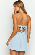 Rear view of a light blue strapless mini dress with a back tie closure and elasticated waist