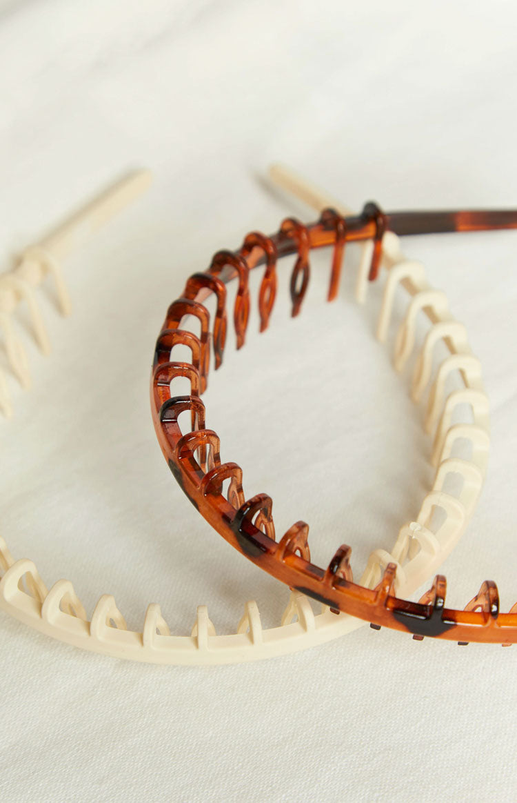 Close-up of the cream and tortoiseshell headbands showing the comb teeth detail