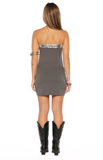 Rear view of a grey strapless mini dress with a silver sequin trim along the top