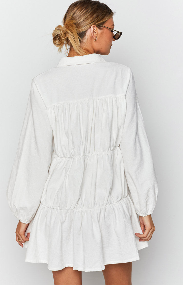 White textured tiered mini dress with gathered back yoke, elasticated waist, and long sleeves