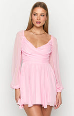 Pink mini dress with a sweetheart neckline, ruched bust, and sheer long sleeves
