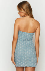 Rear view of a light blue denim strapless mini dress with a textured white embroidered pattern