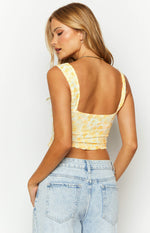 Rear view of a yellow lace crop top with a square back neckline and wide straps