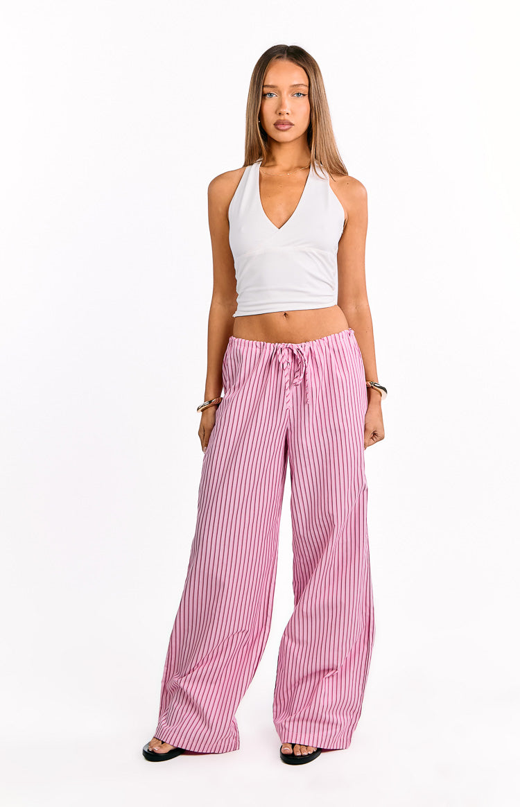 Full length pink wide-leg pants with thin black vertical stripes and a drawstring waist