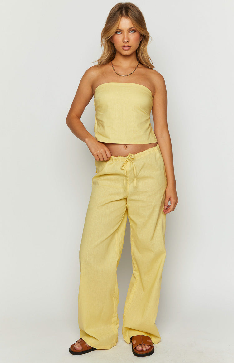 Full length view of yellow wide-leg pants with a drawstring waist and relaxed fit