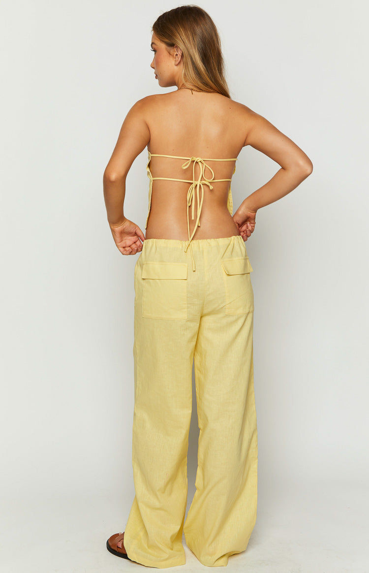 Rear view of yellow wide-leg pants with an elasticated drawstring waist and back flap pockets