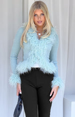 Mint green ribbed knit cardigan with shaggy fur trim along the V-neckline and cuffs
