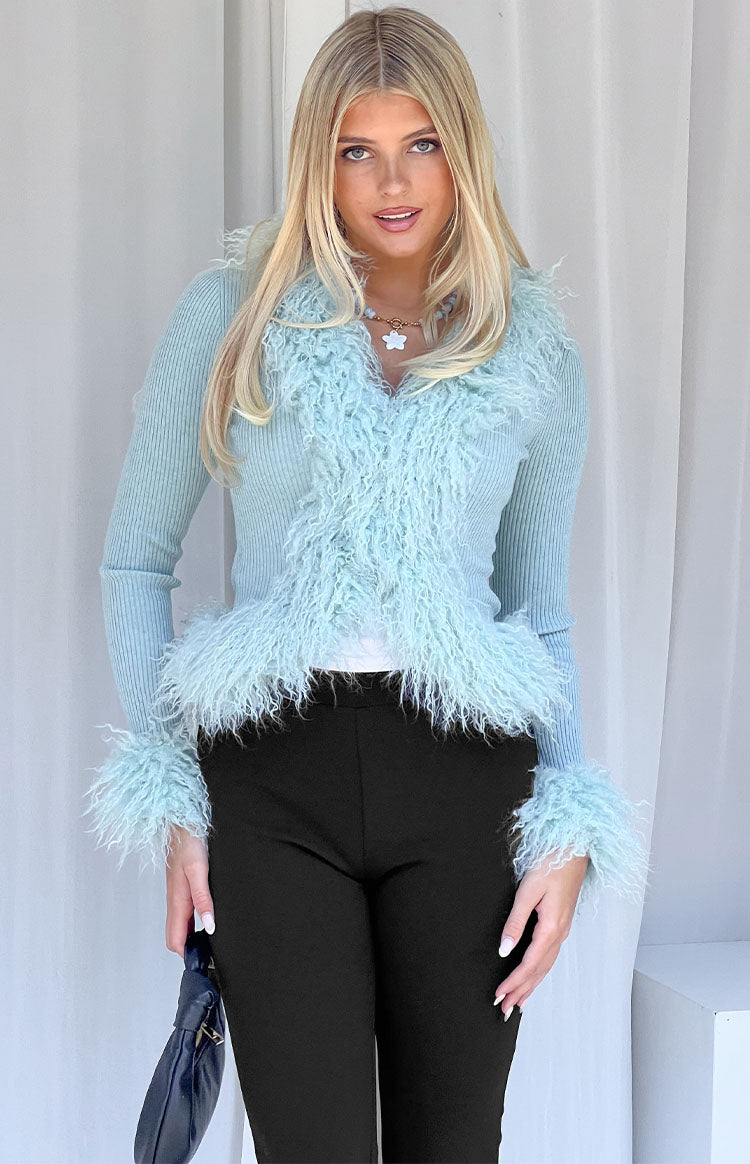 Mint green ribbed knit cardigan with shaggy fur trim along the V-neckline and cuffs