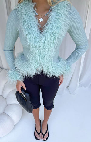 Mint green ribbed knit cardigan with shaggy fur trim around the V-neck, hem, and cuffs
