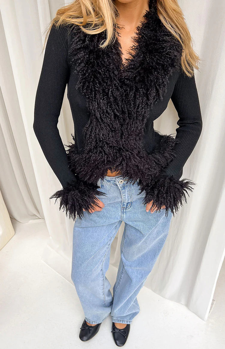 Black ribbed knit cardigan with shaggy fur trim along the V-neckline, front opening, and cuffs