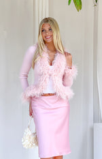 Pink ribbed knit cardigan worn open, featuring fluffy fur trim along the front edges, V-neckline, and cuffs