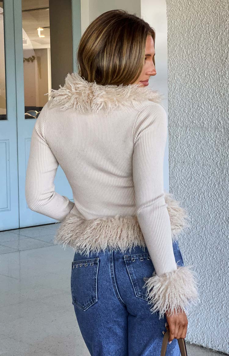 Beige ribbed knit cardigan with fluffy fur trim along the V-neckline and cuffs, cropped length
