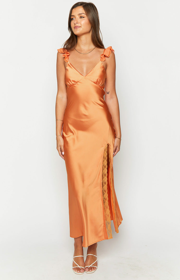 Orange satin maxi dress with ruffled shoulder straps and a high leg slit with lace trim