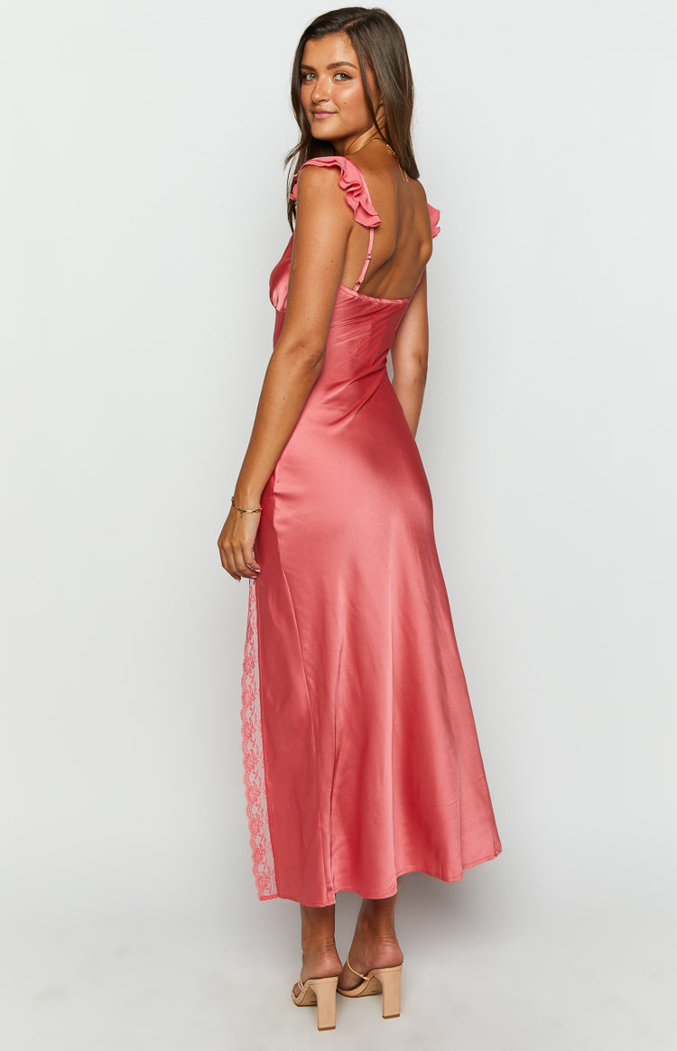 Side view of a coral pink satin maxi dress with ruffled shoulder straps and a lace insert panel