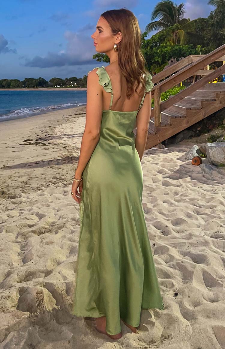 Rear and side view of a sage satin maxi dress with ruffled shoulder straps and a flowy skirt