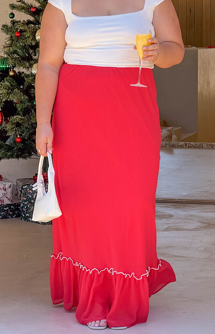 Red maxi skirt with a flowy silhouette and a ruffled hemline featuring white piping