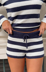 Close-up of navy and white striped knit shorts showing the ribbed elastic waistband and drawstring