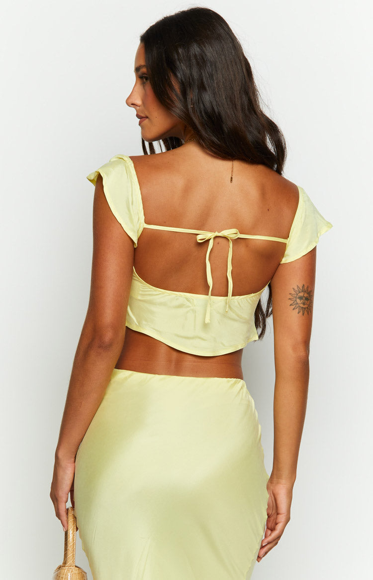 Close-up of the yellow top's sweetheart neckline, ruched bust detail, and gathered short puff sleeves
