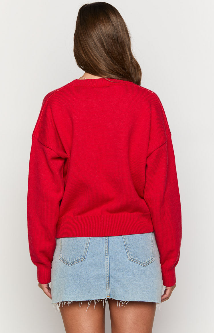 Rear view of a red knit sweater with dropped shoulders and a ribbed hem