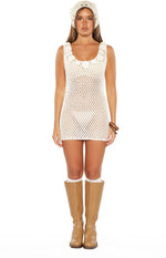 Front view of a white open knit crochet mini dress with floral appliques on the scoop neckline