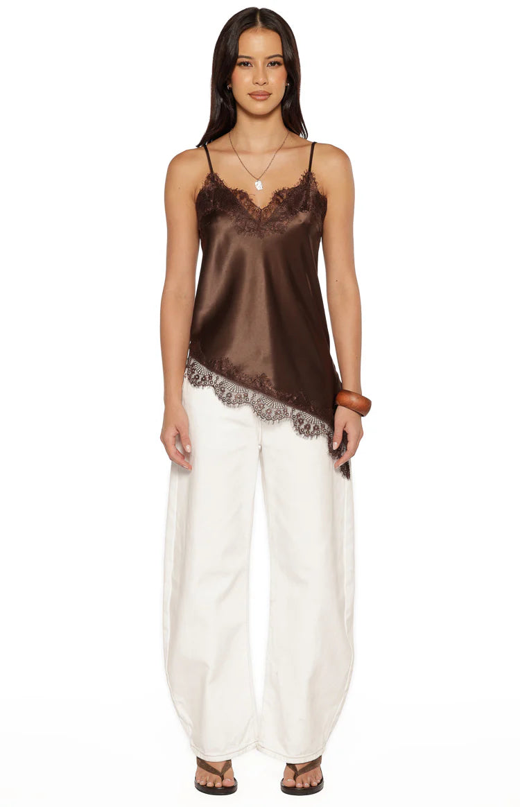 Front view of a brown satin top with lace-trimmed V-neckline and a distinct asymmetrical hemline