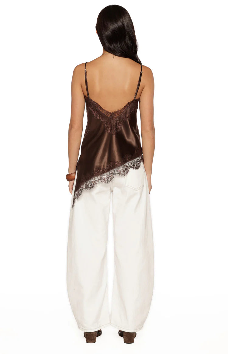 Rear view of a brown satin asymmetrical top with a low lace-trimmed scoop back and an asymmetrical lace hem