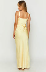 Rear view of a yellow satin maxi dress with a straight back and adjustable spaghetti straps