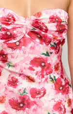 Close-up of the ruched sweetheart neckline and pink floral pattern of a maxi dress