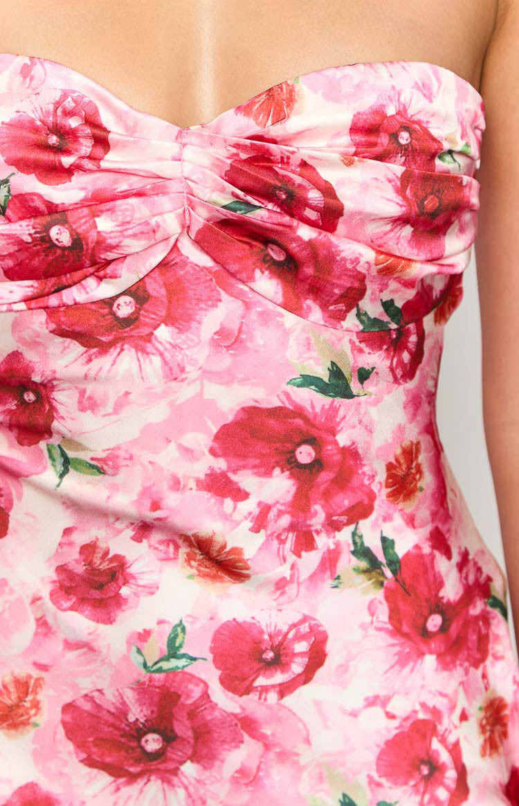 Close-up of the ruched sweetheart neckline and pink floral pattern of a maxi dress