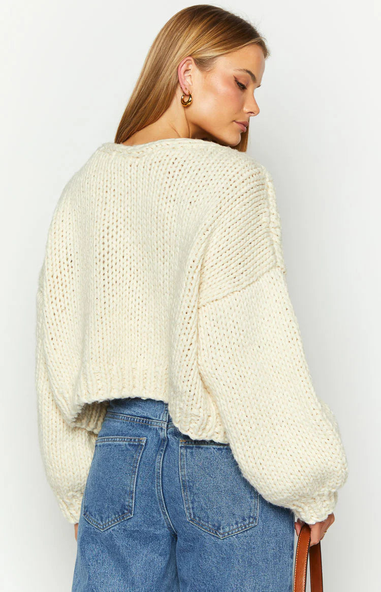 Cream chunky knit cardigan with a wide boat neck, dropped shoulders, and long balloon sleeves