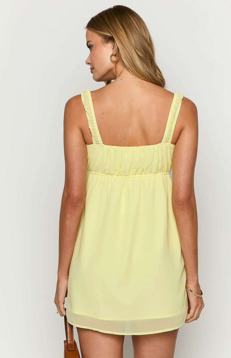 Rear view of a yellow mini dress with ruched straps and an elasticated back waist