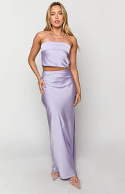 Full length view of a lilac satin slip maxi skirt with a flowy fit and a side slit