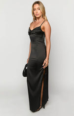 Side view of a black satin maxi dress with a ruched bust, thin spaghetti straps, and a high side slit