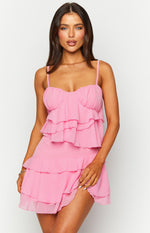 Pink mini dress with a ruffled sweetheart neckline, spaghetti straps, and tiered ruffle skirt