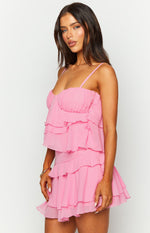 Close-up side view of the pink mini dress with a ruched bust and tiered ruffles on the skirt