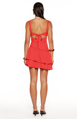 Rear view of a red mini dress with a tie-back cutout and tiered ruffle skirt