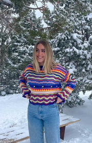 Cropped multi-colour knit sweater with horizontal zig-zag and heart stripes, a crew neck, and long sleeves