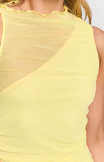 Close-up of the sheer yellow mesh fabric, ruffled high neckline, and ruched bodice of the maxi dress