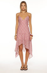 Front view of a pink and white plaid midi slip dress with a V-neck, spaghetti straps, and hanky hem