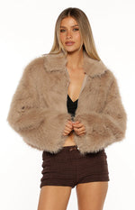Light brown faux fur cropped jacket with a wide collar and open zip front, showing its fluffy texture
