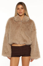 Front view of a light brown faux fur jacket with a collared neckline, full zip, and wide long sleeves