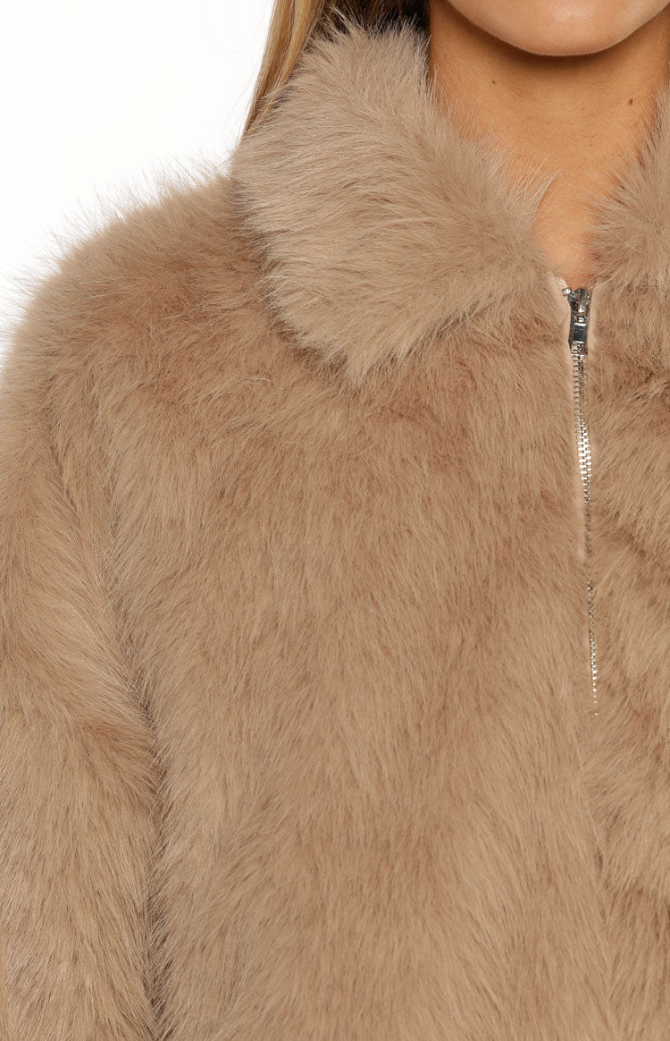 Close-up of the light brown faux fur texture, collar, and silver zipper detail on the jacket