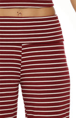 Close-up of the foldover waistband and burgundy and white horizontal stripes on knit wide leg pants