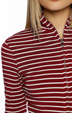 Close-up of the burgundy and white striped sweater with a silver zipper detail on the high neck